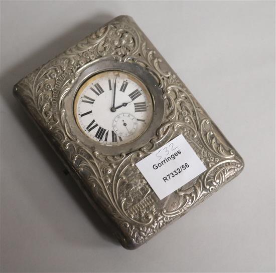 A late Victorian repousse silver travelling watch case, with pocket watch, Henry Matthews, Birmingham, 1899, 15.3cm.